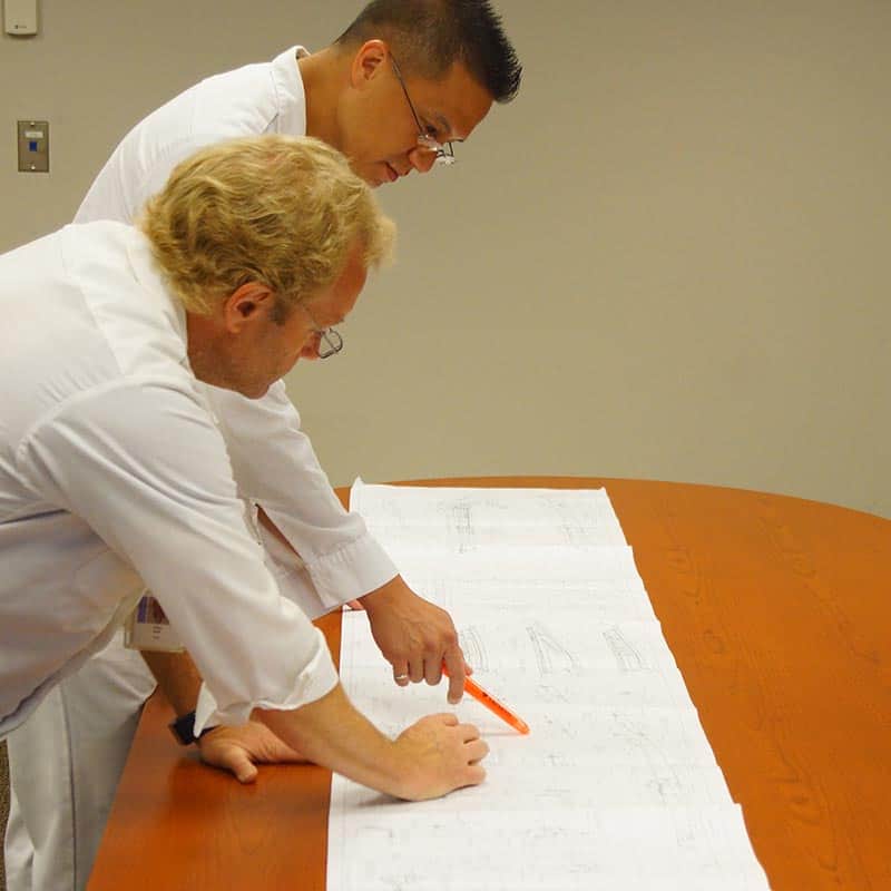 Research and Development team looking at blueprints