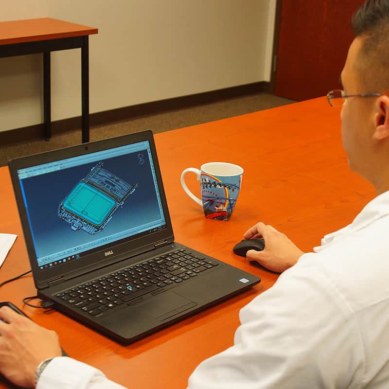 Man designing sunroof on laptop